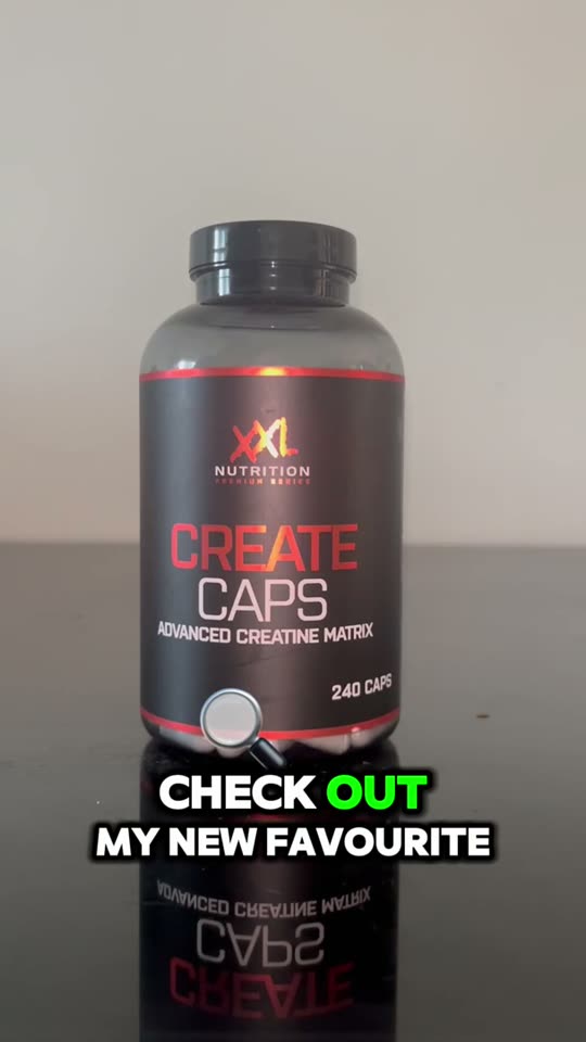 A tub of creatine capsules held to camera