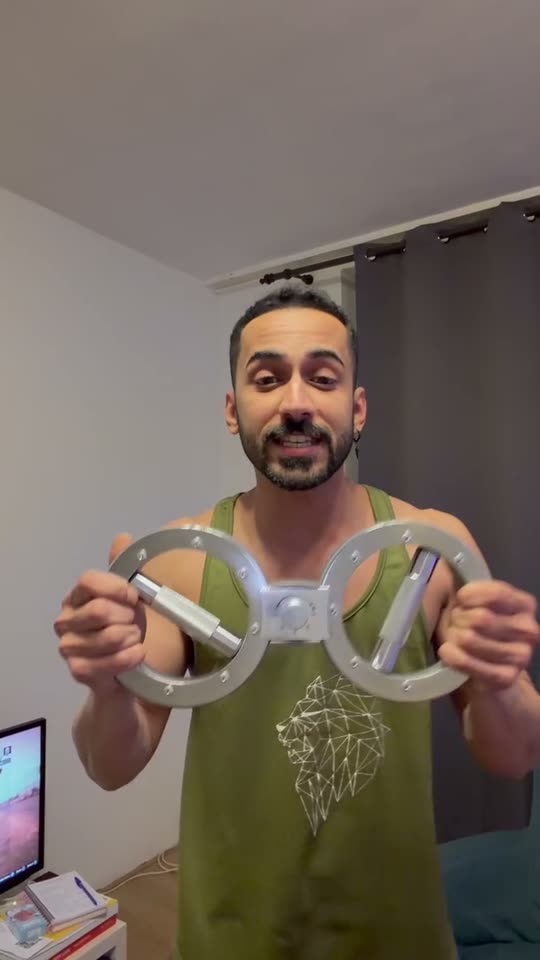 Moo holding up a grip and dumbbell trainer